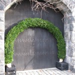 boxwood-covered arches